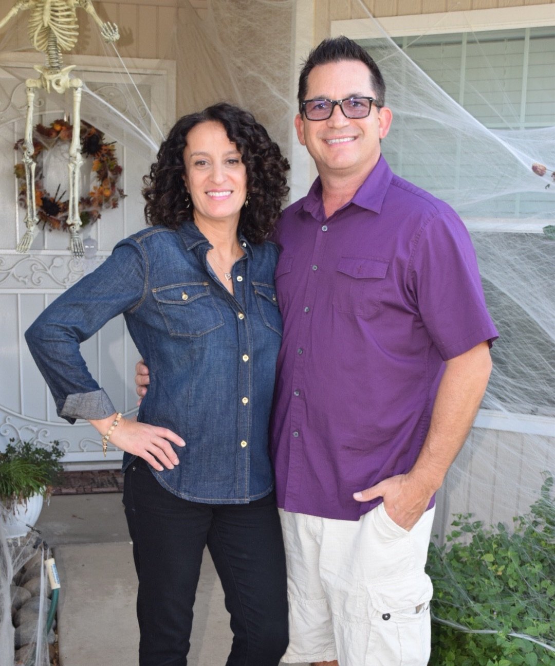Todd Valdez and his wife, Deanna, standing together on the front porch of their home.
